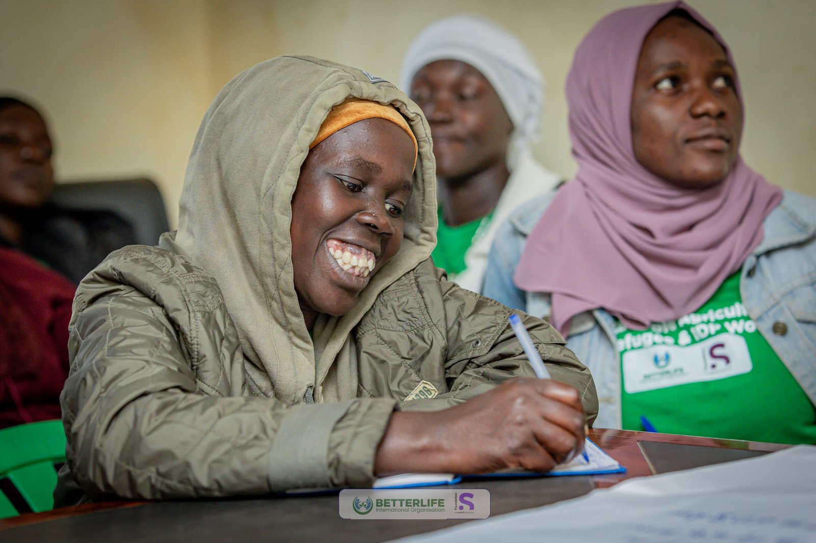 A woman taking notes during a BetterLife training session