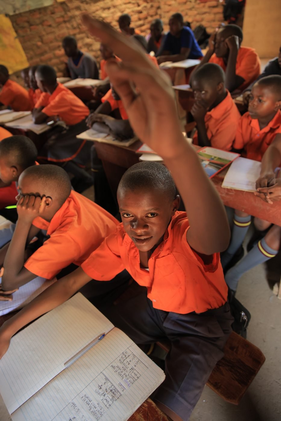 A pupil raising his hand in class in Rukungiri