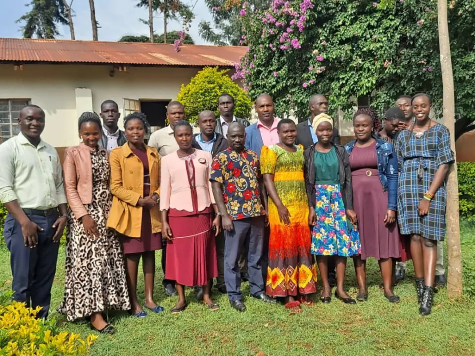 Denise Ayebare standing with a group of people outdoors