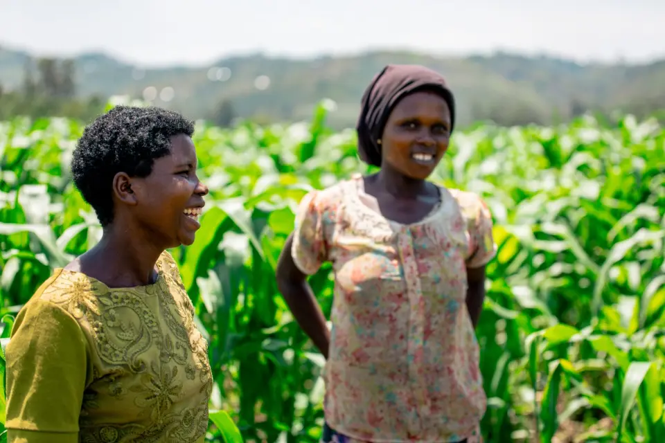 Two women smiling in a maize field