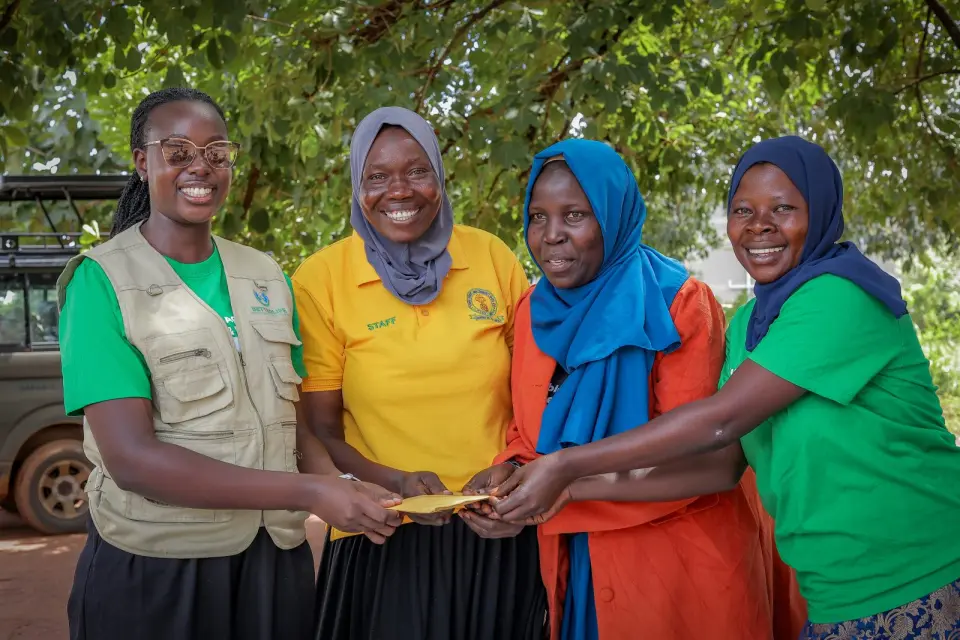 Four women smiling together in Yumbe