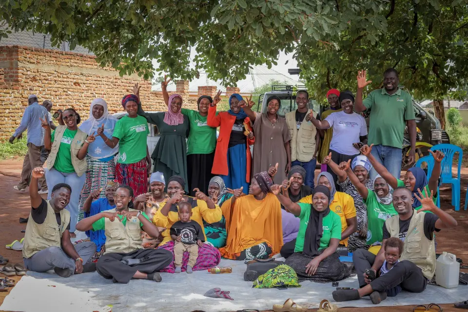 Programme participants and BetterLife staff celebrating together under a tree in Yumbe