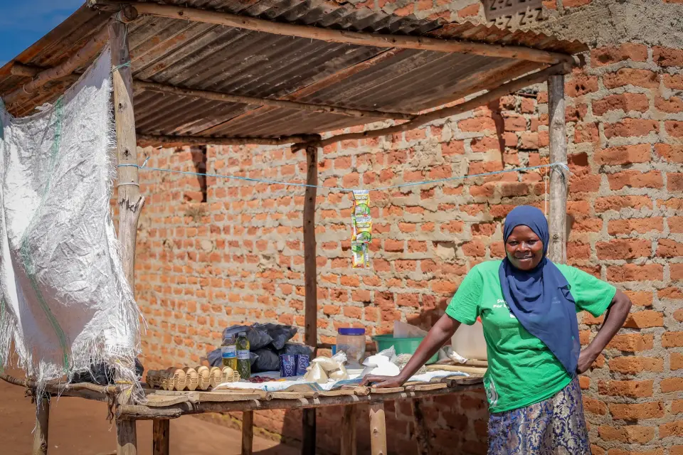 A woman standing at her market stall in Yumbe