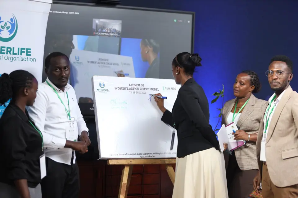 Signing the board at the launch of the Women’s Action Circle model in 12 districts