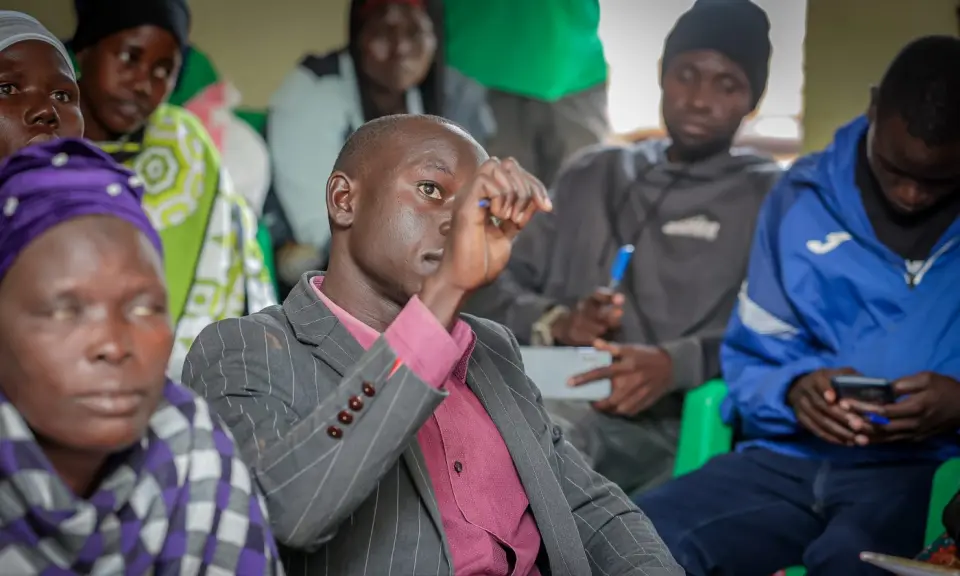 Participants at a training session in Yumbe, one checking a phone