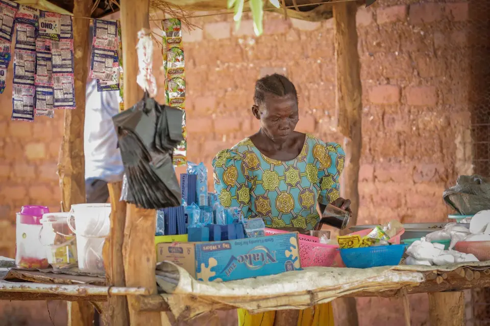 A woman serving at her shop counter in Yumbe