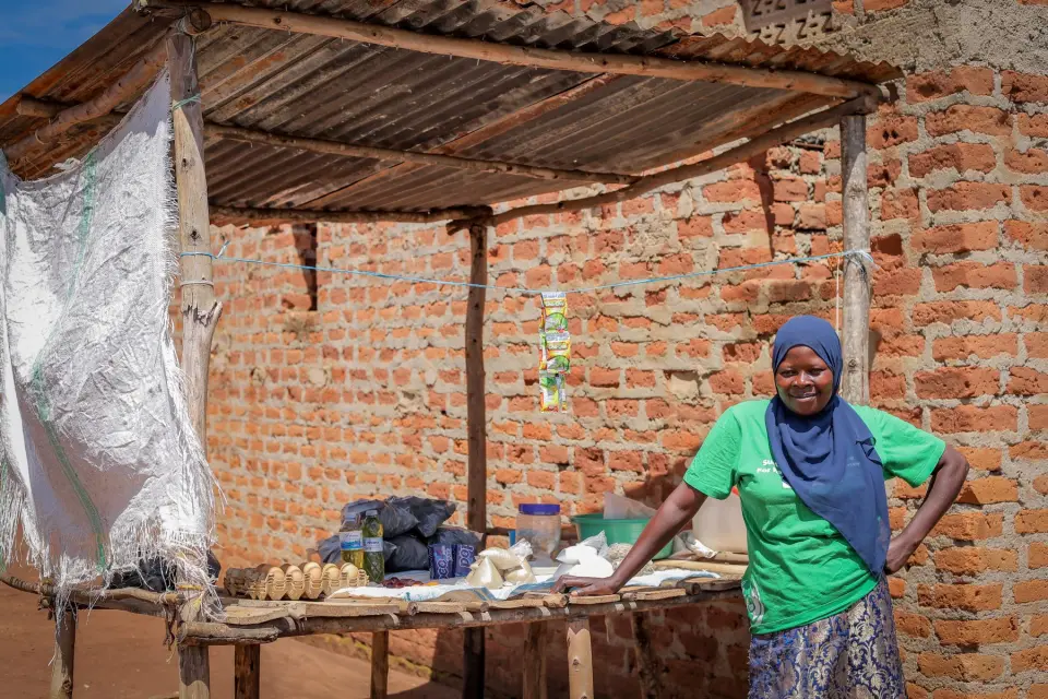 A woman at her stall beside a brick shop