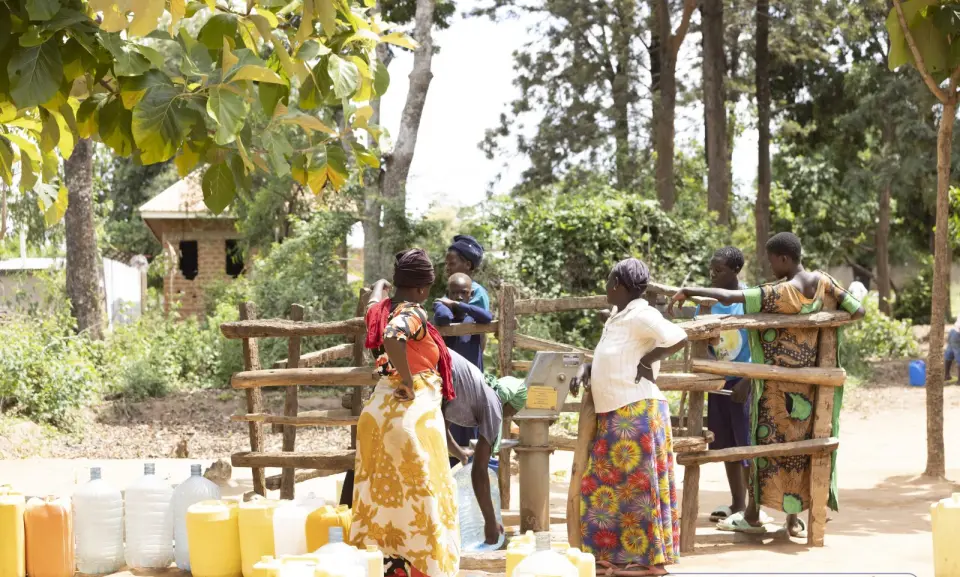 Women collecting water at a water point in Yumbe