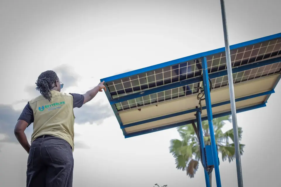 A BetterLife team member checking a solar panel in Yumbe