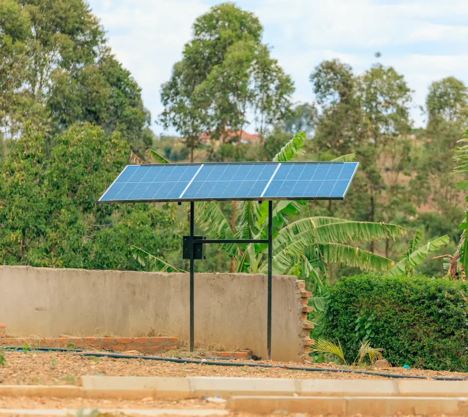 A solar panel installed above a raised water tank