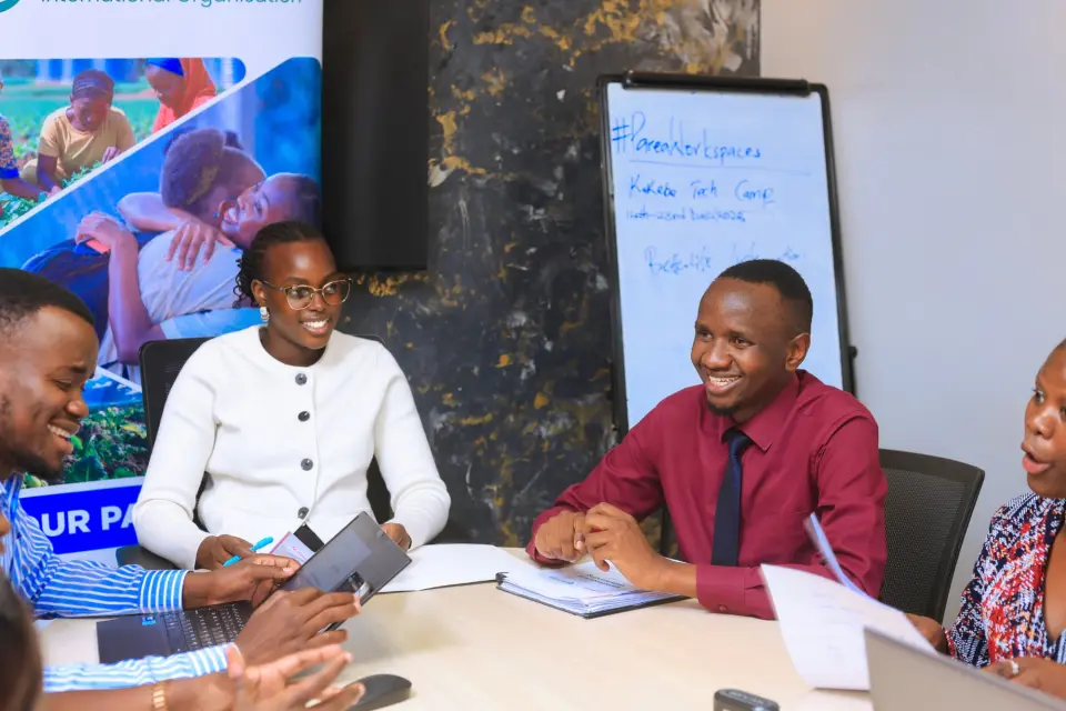 Denise Ayebare and Sedrick Otolo smiling during the partnership meeting
