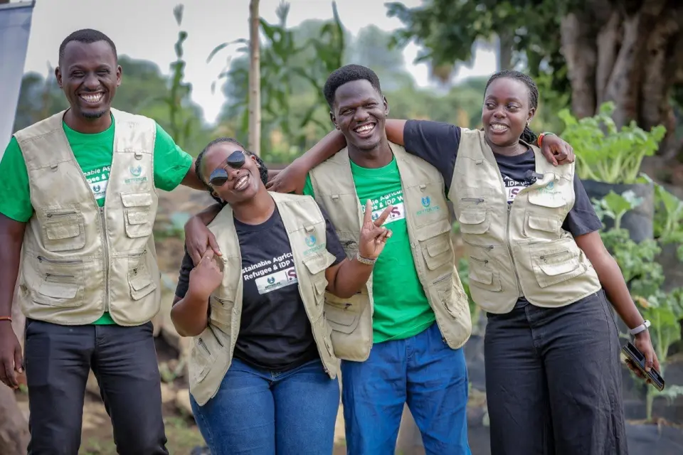 Four BetterLife team members laughing with their arms around each other