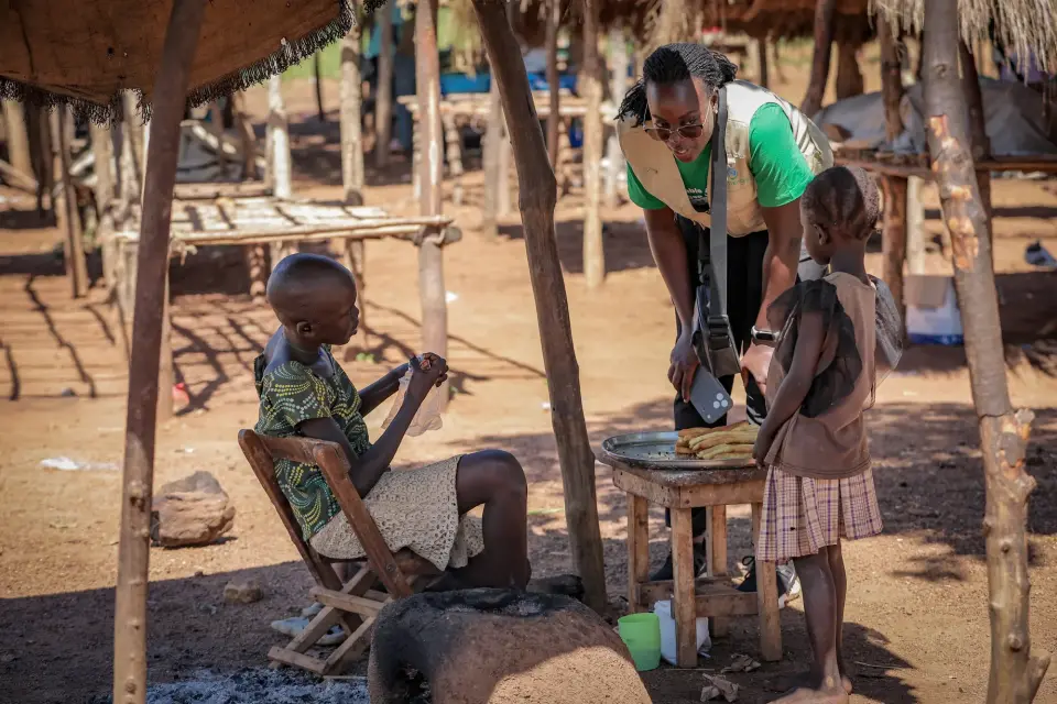 A woman preparing food at her stall in Yumbe