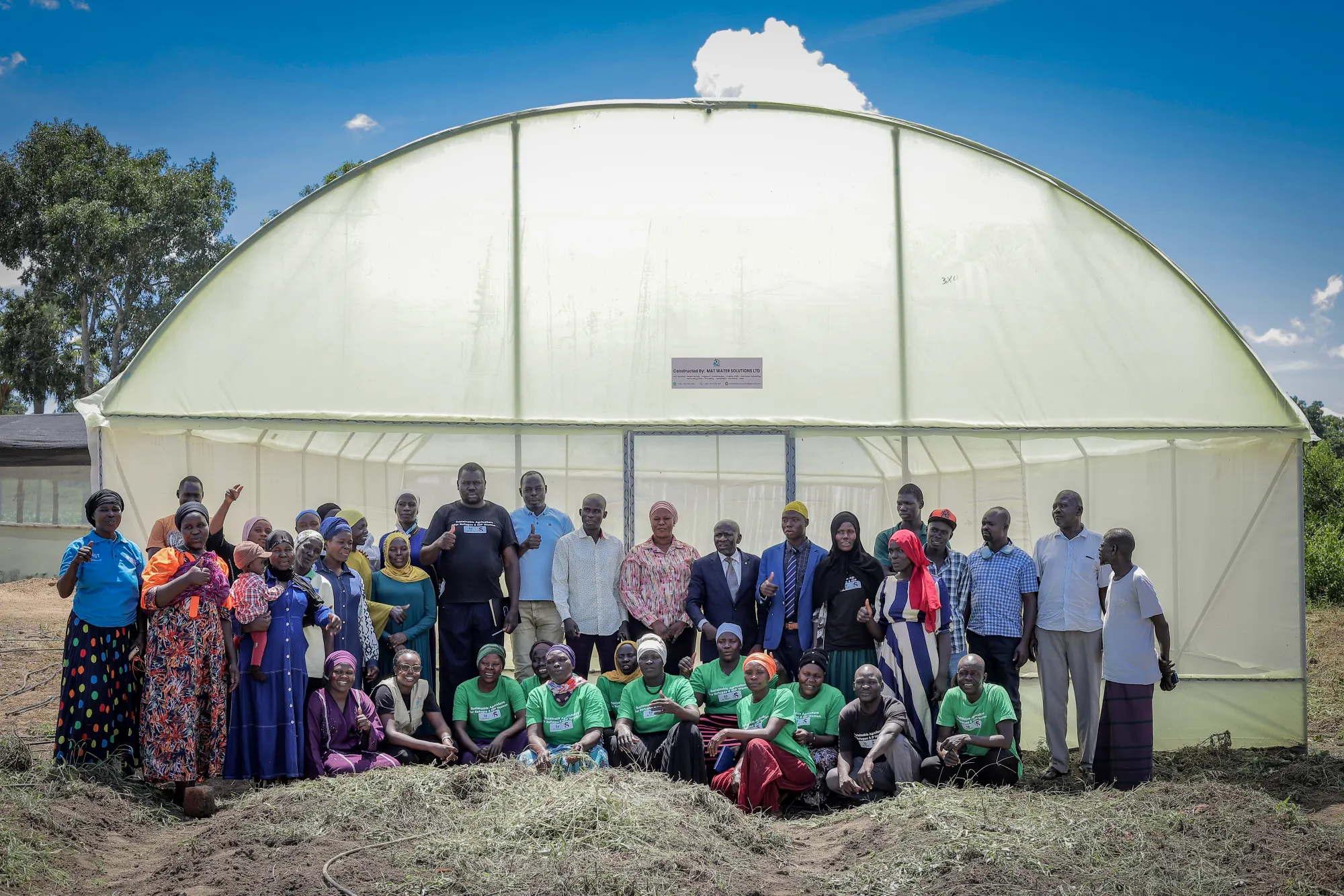 Building a greenhouse with women in Yumbe